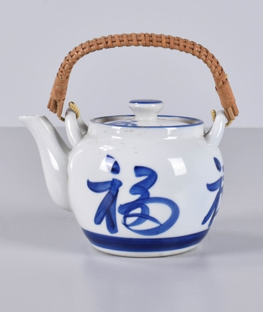 main photo of White and Blue Asian Teapot with Rattan Handle