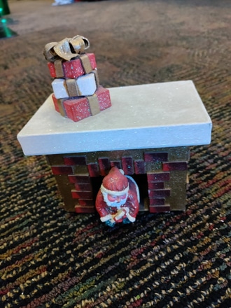 main photo of Paper Mache Santa comming out of Fireplace