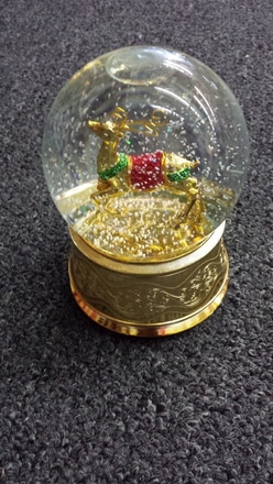 main photo of Snow globe with gold reindeer