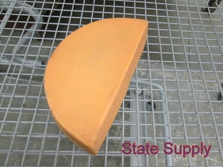 main photo of fake food cheese wheel half yellow