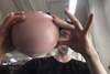 spherical round vase with small foot. white bottom, pink top