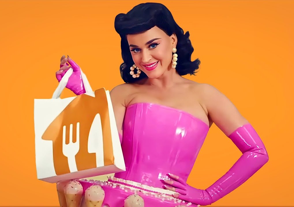 Katy Perry posing with packaging graphics for film and TV