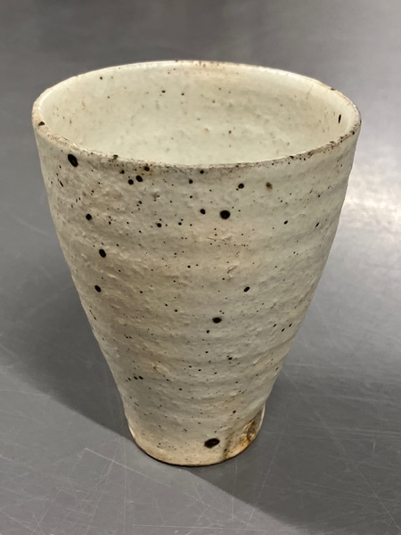 main photo of off white w/ brown specs individual table vase