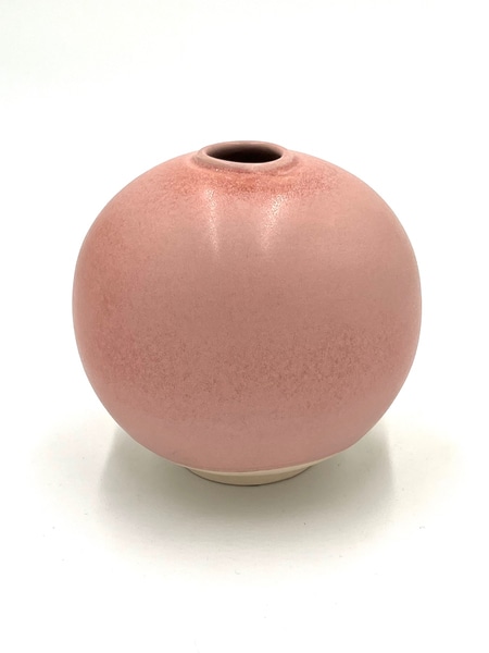 main photo of spherical round vase with small foot. white bottom, pink top
