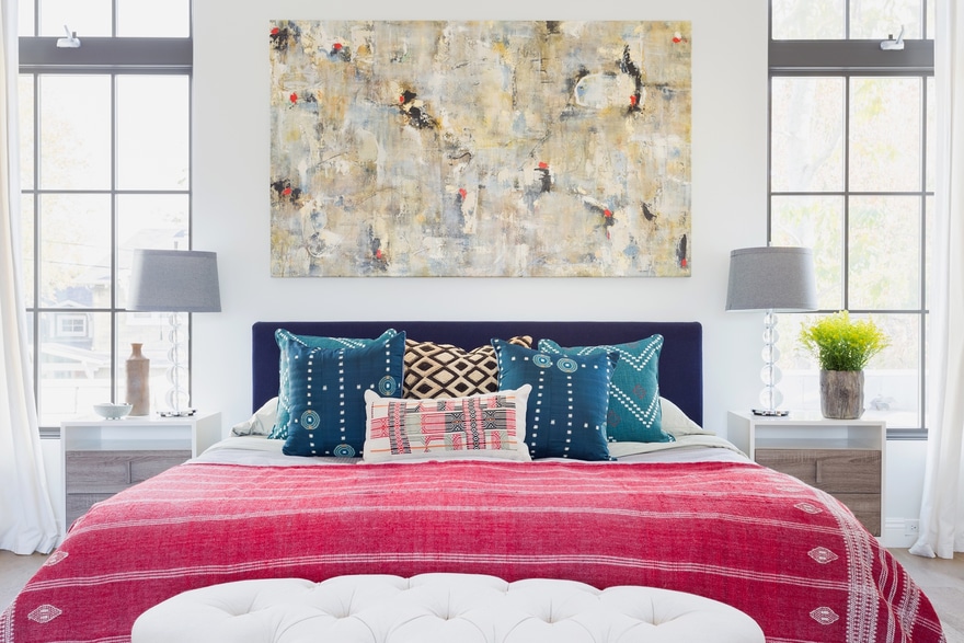 art installation of abstract painting in bedroom above bed